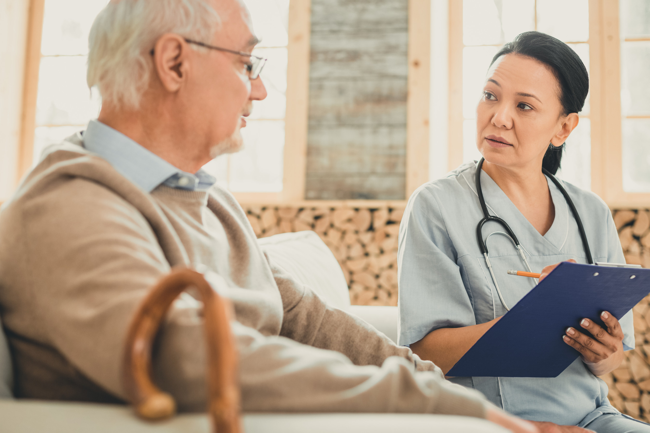 Attentive female with dark hair writing down indications Attentive female with dark hair writing down indications